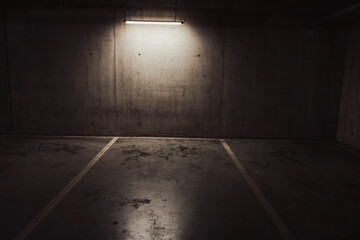 Empty parking lot with overhead dim light