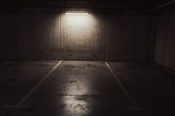 Empty parking lot with overhead dim light