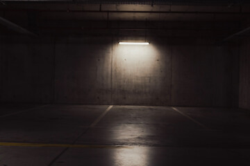 Empty parking lot with overhead dim light