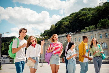 Group of Diverse Young Friends Enjoying a Sunny Day Together While Walking in a Modern Urban Setting