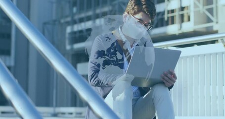 Seated mature man tapping laptop on stairs while world map overlay forming, showing tech network - Powered by Adobe