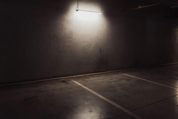Empty parking lot with overhead dim light