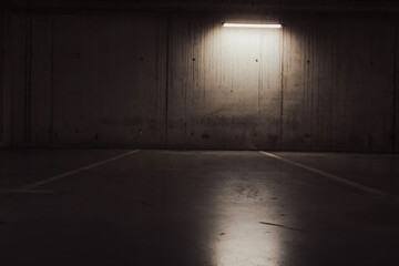 Empty parking lot with overhead dim light