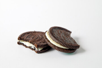 Chocolate cookie with cream on background.