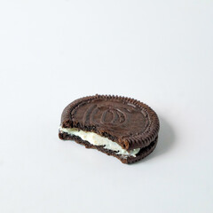 Chocolate cookie with cream on background.