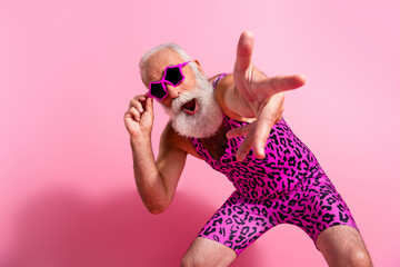 Photo of positive old man dance excited point you wear glamour leopard print overall isolated pink...