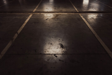 Empty parking lot with overhead dim light