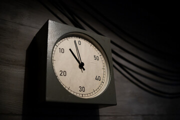 Clock Displaying Time Approaching Zero in a Dimly Lit Room Emphasizing Urgency and Anticipation...