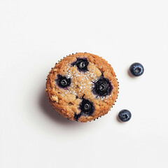 Delicious homemade blueberry muffin sprinkled with powdered sugar and fresh blueberries