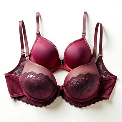 Two maroon bras isolated on white background one with lace detail