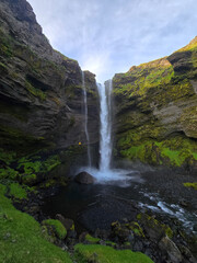 Obraz premium Kvernufoss waterfalls cascading into a serene pool surrounded by lush greenery in Iceland landscapes