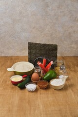 Ingredients for making sushi burgers on light wooden background. Trendy recipes.