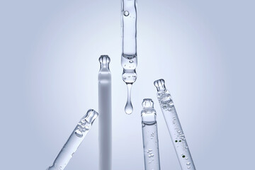 Five different droppers with facial serum.