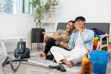 Joyful LGBTQIA Couple Enjoying House Cleaning Together