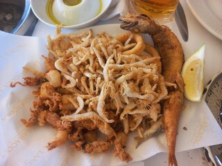 Delicious mediterranean seafood platter with lemon and olive oil for dining indulgence. Pescado...