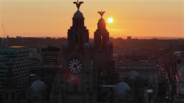 Sun rising over the towers of Liver building in Liverpool UK 