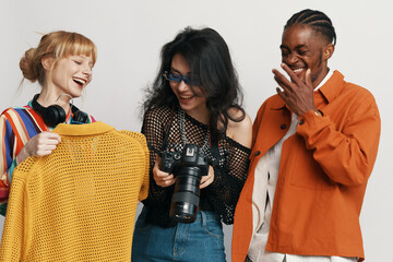 Smiling young adults socializing in workplace, showcasing coworkers and friends from Gen Z enjoying...