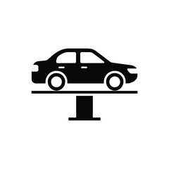 Black silhouette of a car being lifted on a car lift in a service station