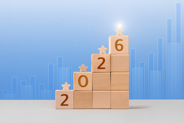Wooden cubes with numbers 2026 and wooden stars are a symbol of success, business progress,...