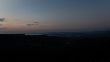 Night view of the ancient Slovenian town of Piran, the Adriatic Sea, sunset and vineyards