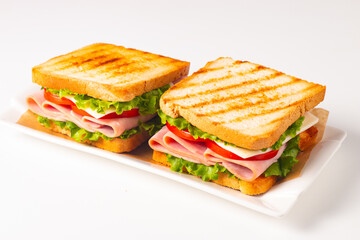 Club sandwich with ham, cheese, tomato and lettuce