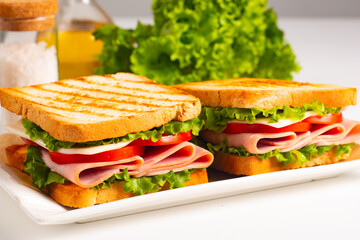 Club sandwich with ham, cheese, tomato and lettuce