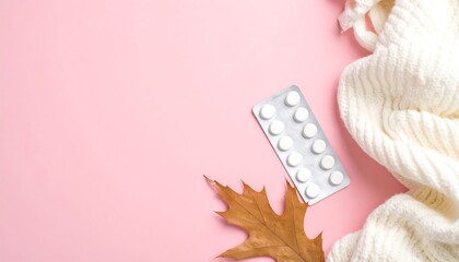 Medicine Blister Pack and Dried Leaf on Pink Surface with White Cloth