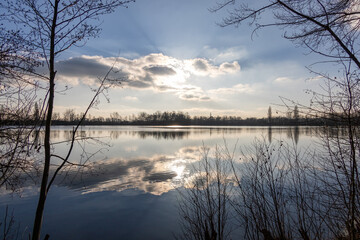 Tranquil Winter Sunset at a Forest Lake with Reflections