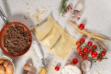 Ingredients for cooking Fried pastry with minced meat on light background, top view.