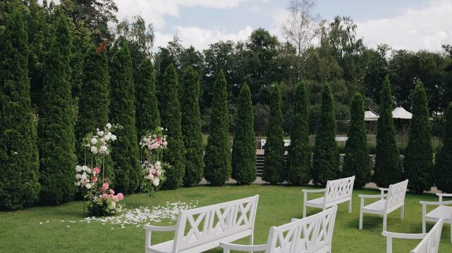 Beautiful park area with a wedding arch and chairs. The ceremony will begin here soon
