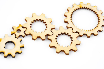 Wooden cogwheels on white background	
