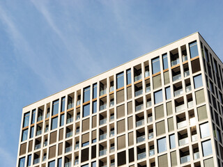 Modern building facade with a lot of windows and balconies. Apartments in a high rise house in Germany, Europe. Expensive rents in an urban area for wealthy people.