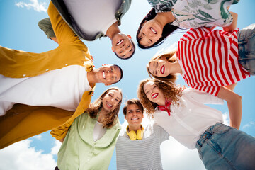 Happy group of friends gathering outdoors under sunny sky experiencing youthful bonding and joy