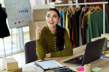 Young creative businesswoman working in a stylish atelier office while brainstorming new ideas for...