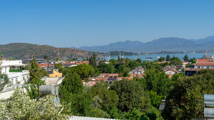 View of Fethiye city, marina and Mediterranean Sea, Turkey. Walking around resort town at foot of the mountains in southwestern Turkiye