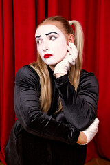 On stage is a pantomime artist with a dramatic expression on his face. Close-up portrait against a...
