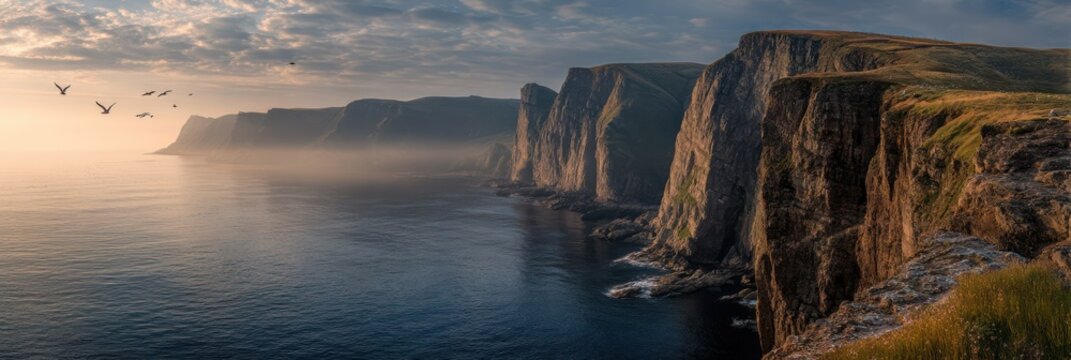 Panoramic view of majestic coastal cliffs and the open sea with birds in flight at sunset - Powered by Adobe