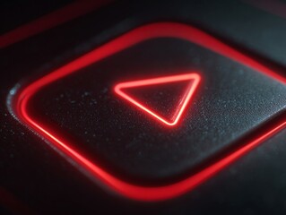 Close-up of a red play button icon glowing on a digital screen