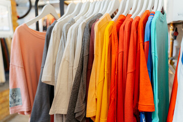 Colorful T-Shirts Hanging on Rack in Clothing Store