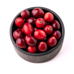 Cranberry. Cranberries in a black bowl isolated on white background.
