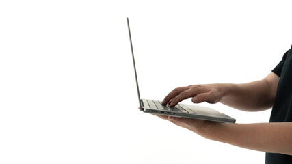 Typing on a sleek laptop with a minimalistic background in a modern workspace environment