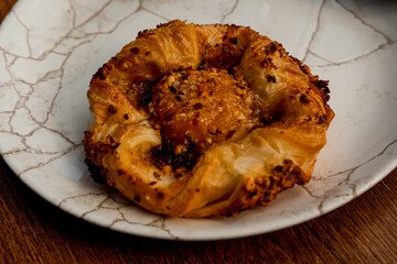 Peach danish pastry. Simple sweet breakfast bun. Pastry on a plate. Crispy delicious breakfast