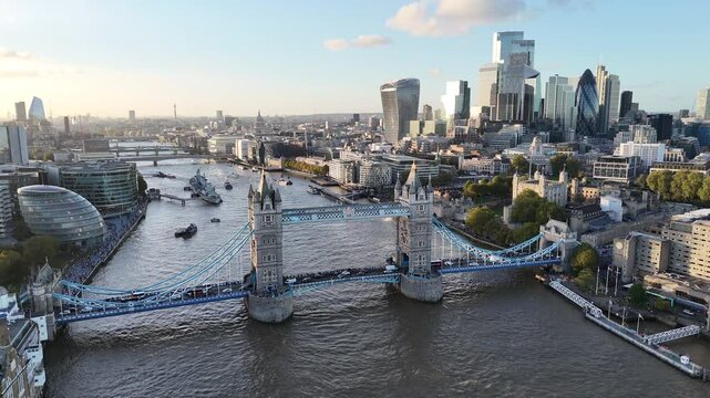 Aerial shot of Tower Bridge and the City of London skyline with modern skyscrapers and the River Thames on a clear day.