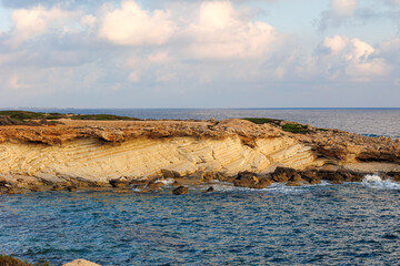 Eroded Coastal Cliffs by the Mediterranean Sea, Golden coastal rock formations shaped by erosion,...