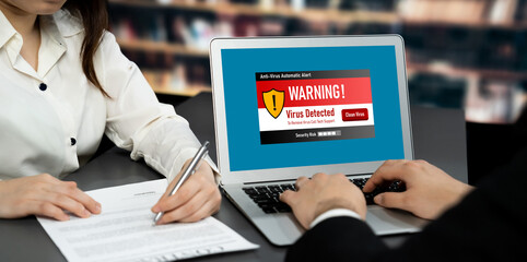 Virus warning alert on computer screen detected brisk cyber threat , hacker, computer virus and...