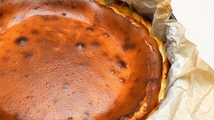 Stunning Top View of a Delicious Homemade Baked Cheesecake with Cracks on White Background
