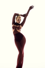 An Elegant Fashion Pose Exhibiting an EyeCatching Sheer Maroon Dress in a Studio Setting