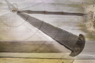 Agricultural irrigation sprinkler watering dry soil on farm field for crops growing during period...