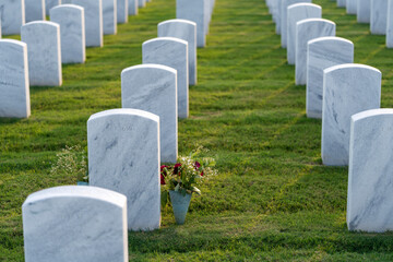 American national military cemetery with rows of white tomb stones on green grass lawn. Memorial...