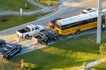 First responders responding to school bus and car accident site on American street. Emergency...